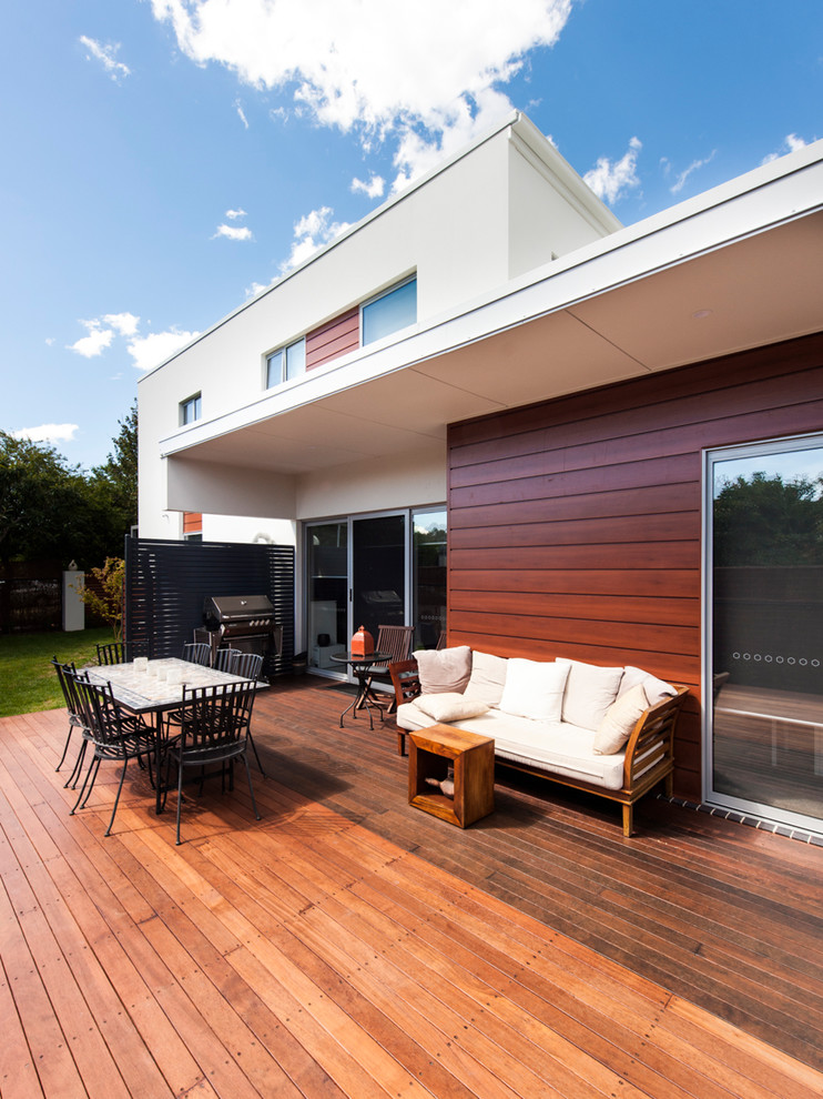 Photo of a large modern side yard deck in Canberra - Queanbeyan with an awning.