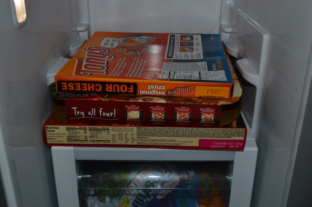 Frozen pizza box in side-by-side fridge