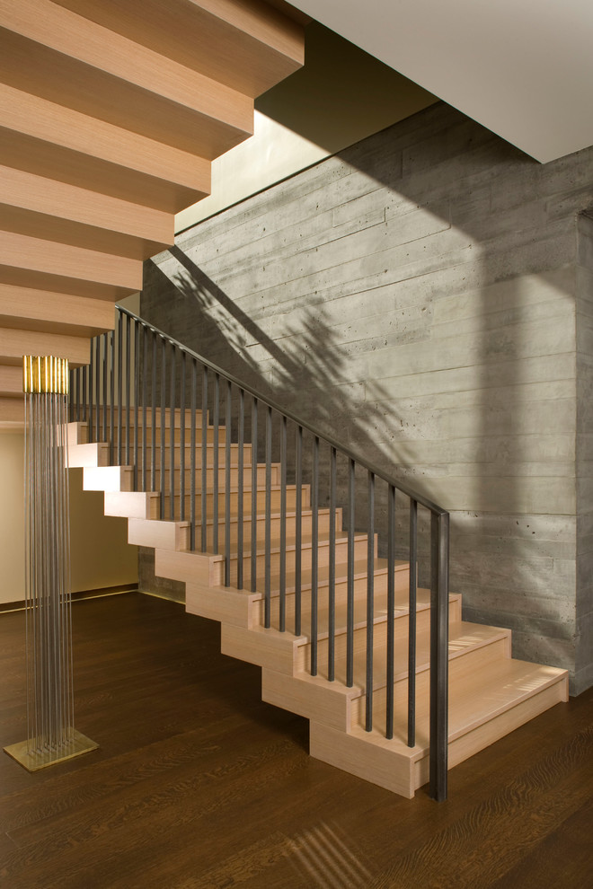 This is an example of a contemporary wood u-shaped staircase in Denver with wood risers.