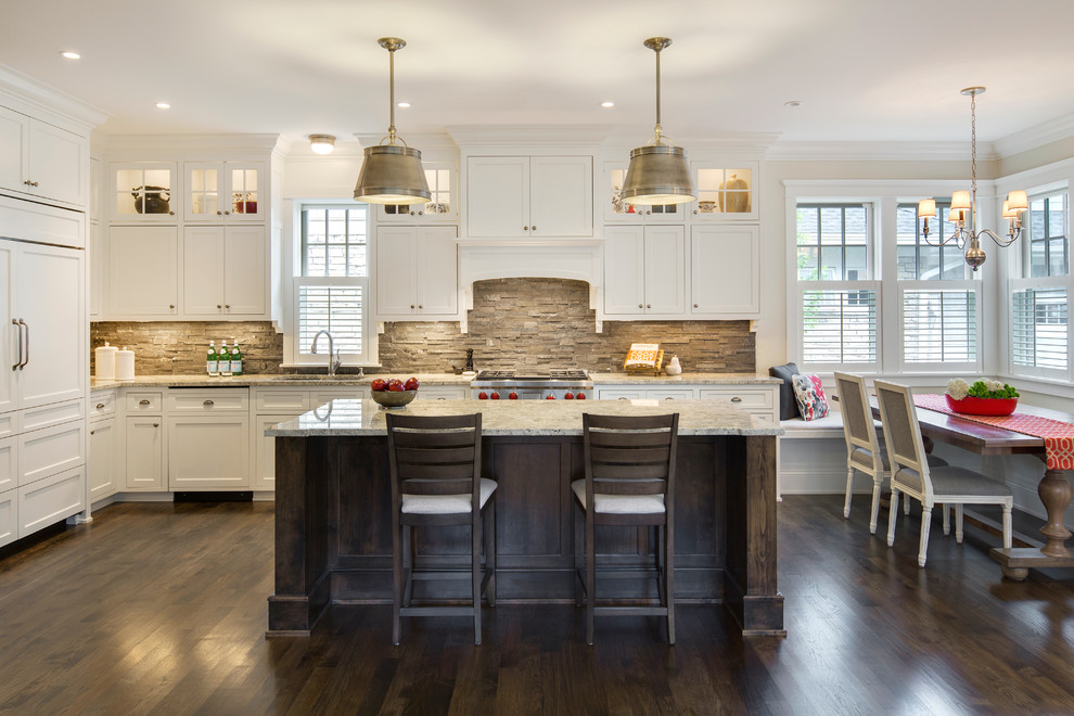 Photo of a traditional l-shaped eat-in kitchen in Minneapolis with an undermount sink, shaker cabinets, white cabinets, granite benchtops, grey splashback, stone tile splashback, panelled appliances, dark hardwood floors and with island.