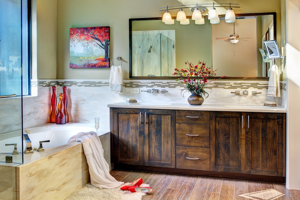 Drop-in bathtub - transitional master brown tile and porcelain tile porcelain tile drop-in bathtub idea in Sacramento with an undermount sink, shaker cabinets, dark wood cabinets, solid surface countertops and beige walls