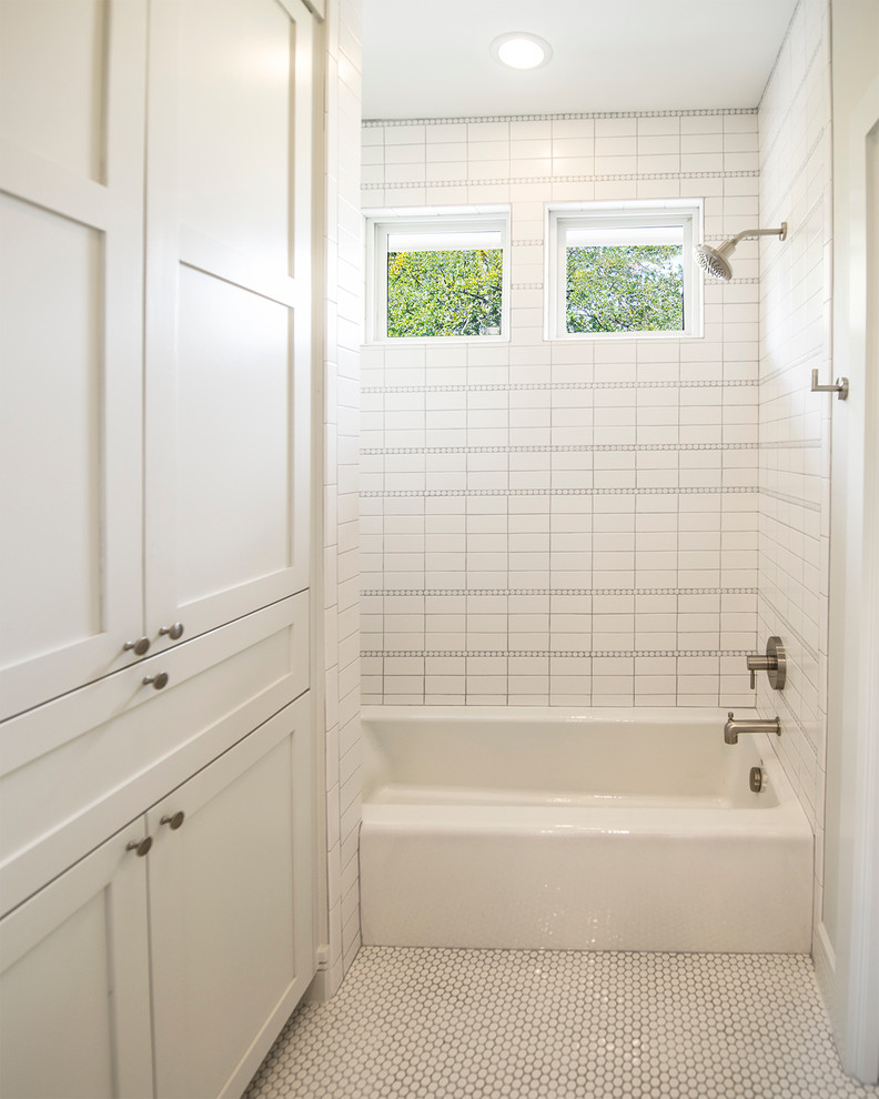 This is an example of a transitional bathroom in Austin with a shower/bathtub combo.