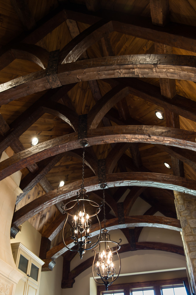 Inspiration for a large rustic galley medium tone wood floor eat-in kitchen remodel with an island, an undermount sink, raised-panel cabinets, distressed cabinets, granite countertops and white backsplash