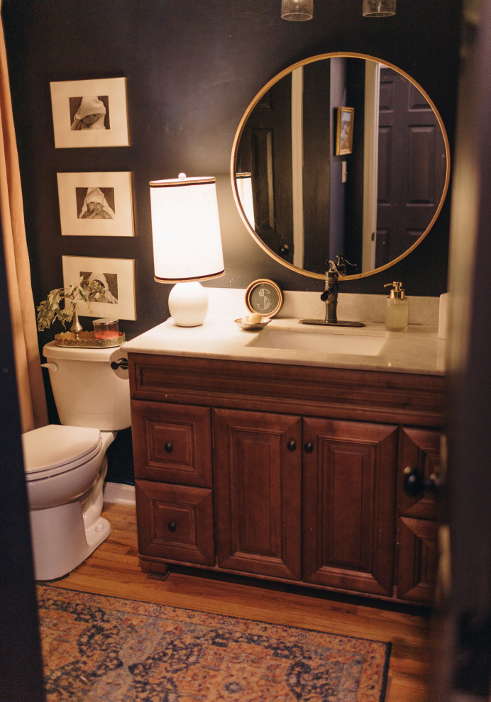 Exemple d'une petite salle de bain chic en bois brun pour enfant avec un placard avec porte à panneau surélevé, une baignoire en alcôve, une douche d'angle, WC séparés, un mur bleu, un sol en carrelage de porcelaine, un lavabo encastré, un plan de toilette en marbre, un sol marron, une cabine de douche à porte coulissante, un plan de toilette blanc, meuble double vasque et meuble-lavabo encastré.