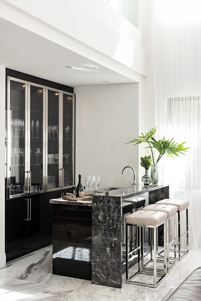 Contemporary seated home bar in Miami with glass-front cabinets, white floor, grey benchtop and marble floors.