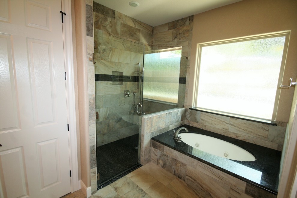 Photo of a traditional master bathroom in Austin with raised-panel cabinets, dark wood cabinets, a corner tub, a corner shower, a two-piece toilet, beige tile, porcelain tile, beige walls, porcelain floors, an undermount sink, granite benchtops, multi-coloured floor, a hinged shower door and multi-coloured benchtops.