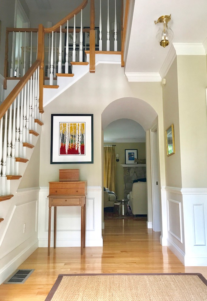Mid-sized transitional light wood floor foyer photo in Boston with white walls and a white front door
