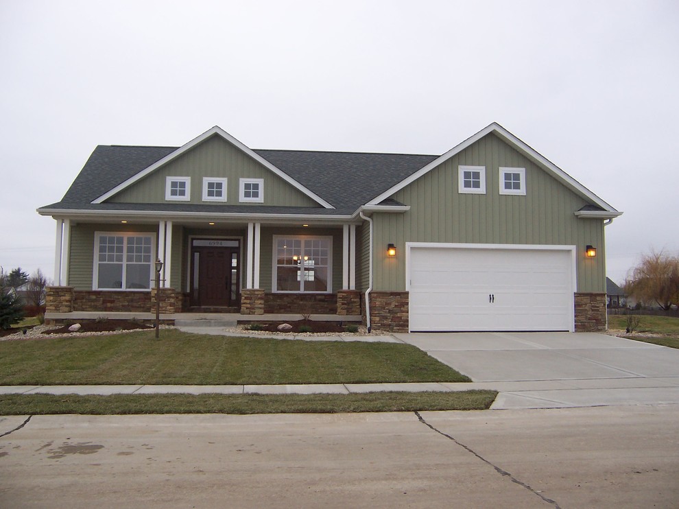 Inspiration for a mid-sized craftsman gray two-story wood house exterior remodel in St Louis with a hip roof and a shingle roof