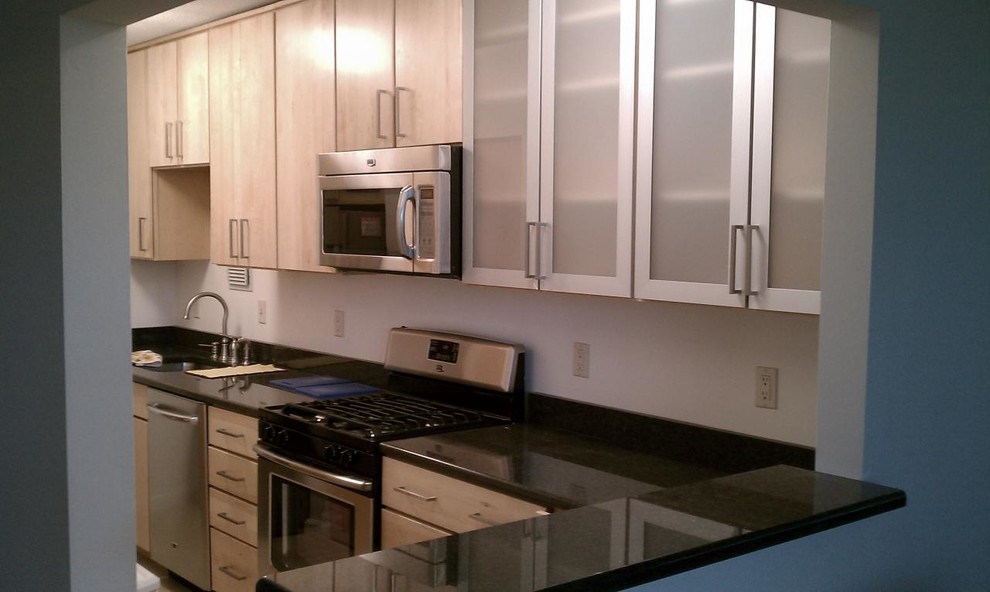 Inspiration for a kitchen remodel in DC Metro with light wood cabinets, white backsplash and stainless steel appliances