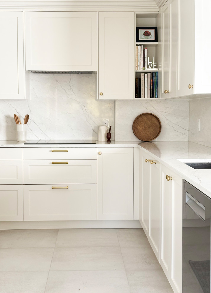 Transitional galley porcelain tile and white floor eat-in kitchen photo in Ottawa with an undermount sink, shaker cabinets, white cabinets, quartz countertops, white backsplash, quartz backsplash, stainless steel appliances, a peninsula and white countertops