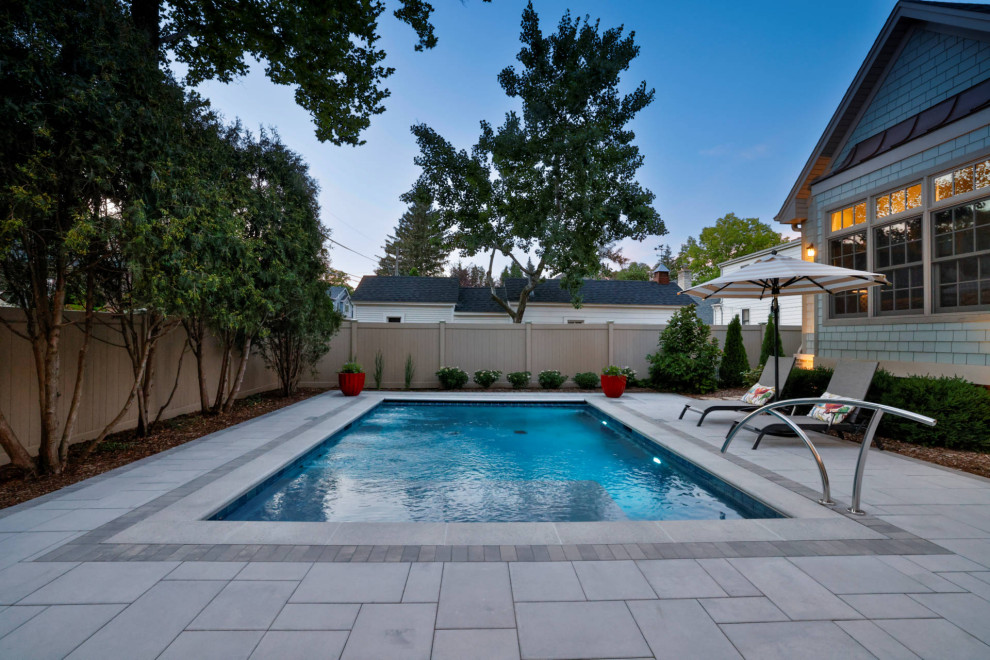 Pool house - small traditional backyard stone and rectangular pool house idea in Chicago