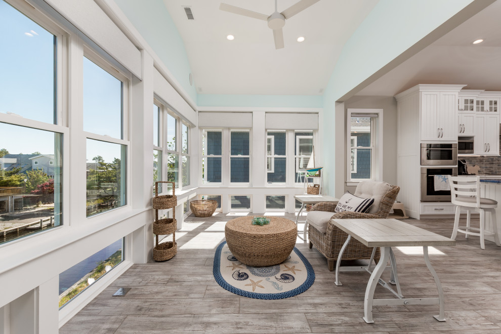 Example of a small beach style laminate floor and gray floor sunroom design in Other with a standard ceiling