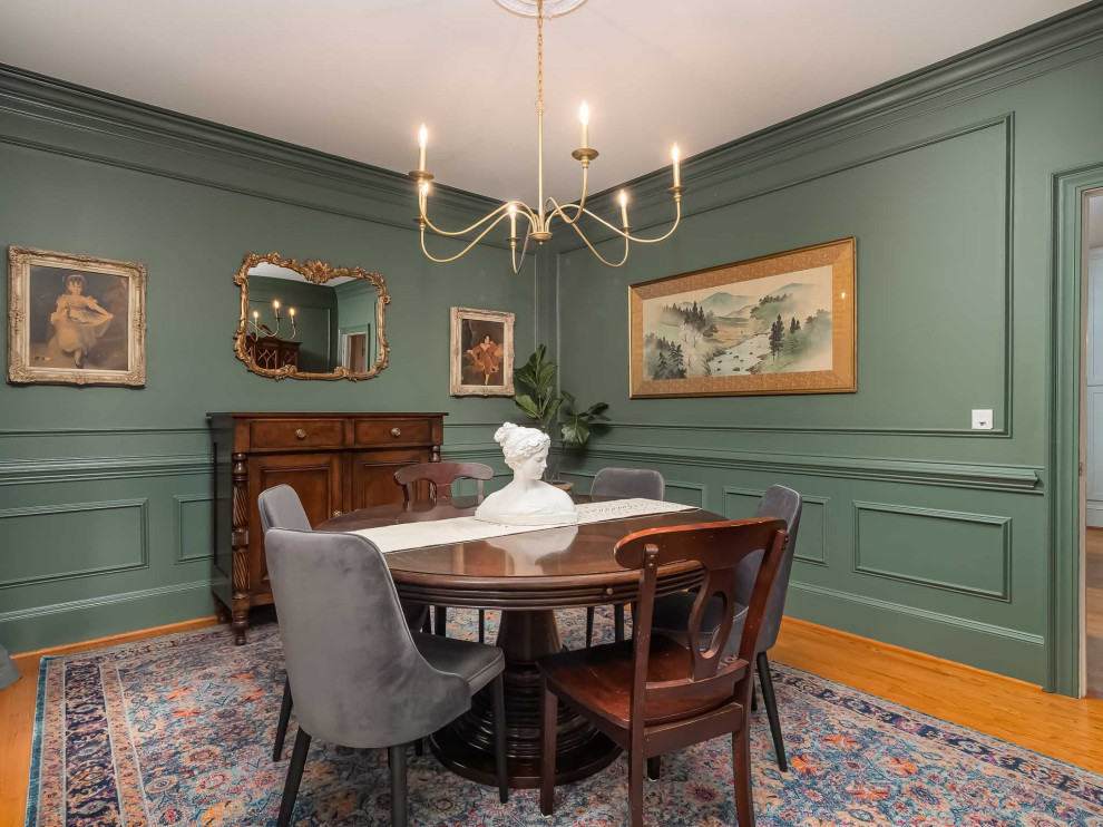 This is an example of a mid-sized traditional separate dining room in Other with green walls, light hardwood floors and yellow floor.