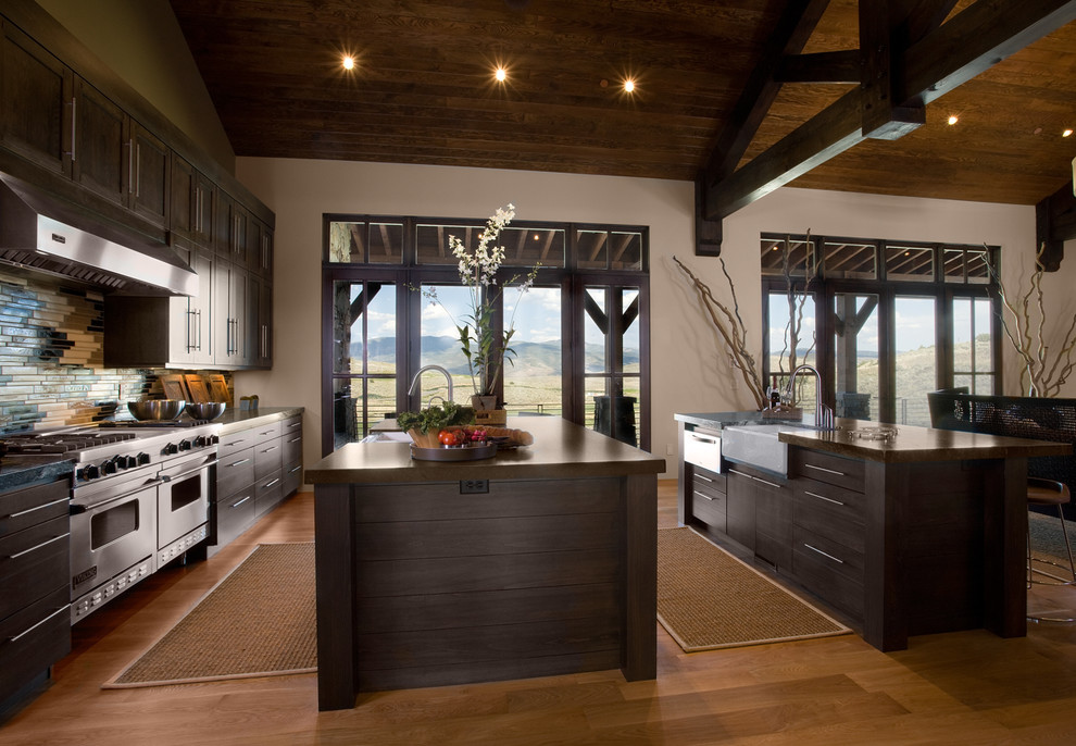 Inspiration for a country kitchen in Salt Lake City with a farmhouse sink, flat-panel cabinets, dark wood cabinets, multi-coloured splashback and matchstick tile splashback.