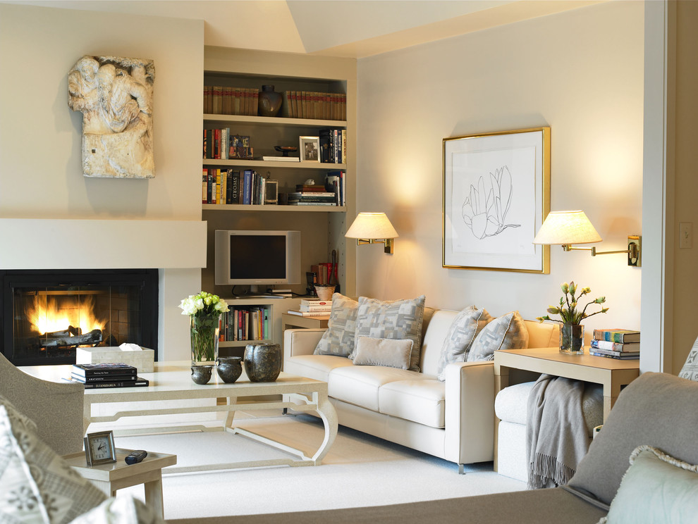 This is an example of a mid-sized transitional formal enclosed living room in Boston with beige walls, carpet, a standard fireplace, a plaster fireplace surround and a freestanding tv.