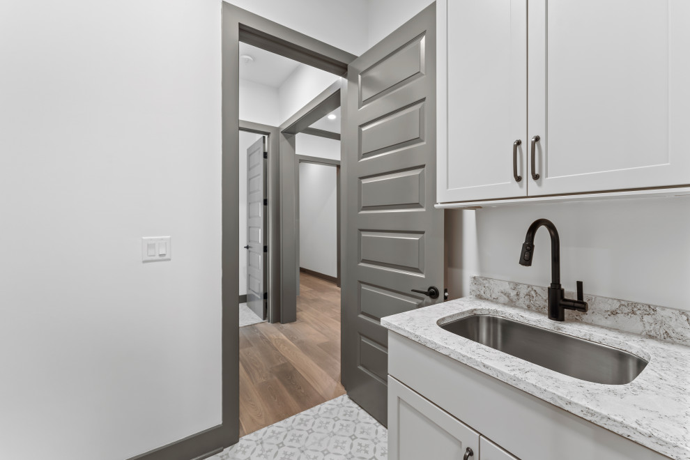 Mid-sized transitional galley dedicated laundry room photo with recessed-panel cabinets, gray cabinets and gray countertops