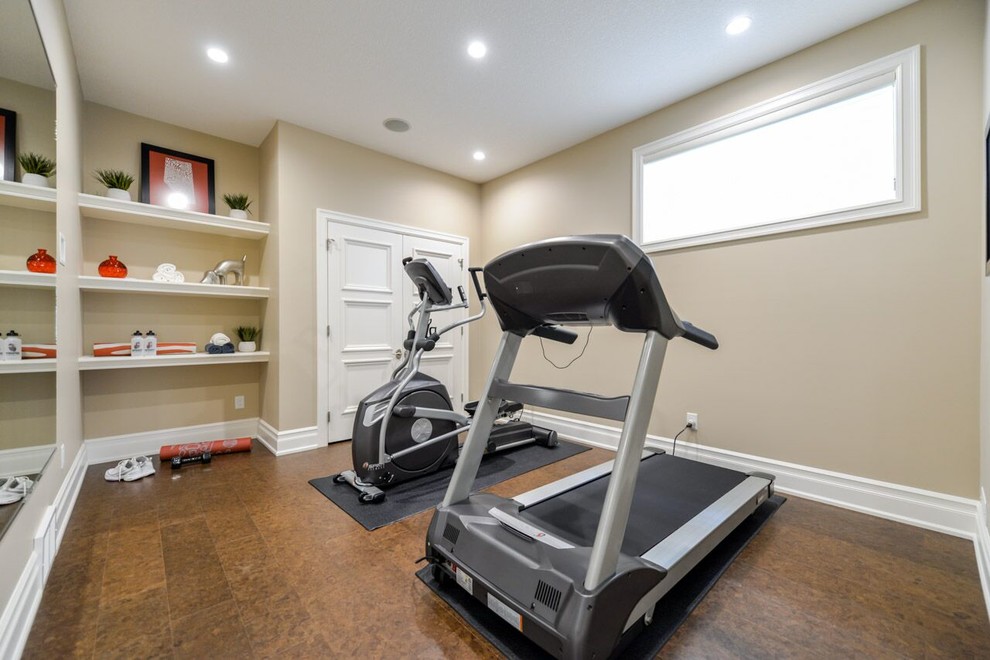 Inspiration for a small transitional multipurpose gym in Calgary with beige walls and cork floors.