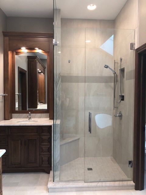 Large transitional master bathroom in Indianapolis with brown cabinets, a freestanding tub, an alcove shower, beige tile, slate, beige walls, porcelain floors, an undermount sink, quartzite benchtops, beige floor, a hinged shower door, white benchtops, beaded inset cabinets and a two-piece toilet.