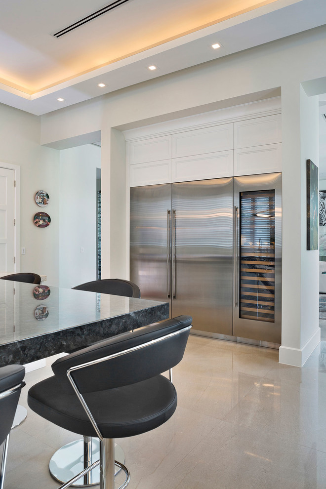 Mid-sized transitional l-shaped ceramic tile and beige floor open concept kitchen photo in Miami with an undermount sink, recessed-panel cabinets, white cabinets, marble countertops, multicolored backsplash, mosaic tile backsplash, stainless steel appliances, an island and multicolored countertops