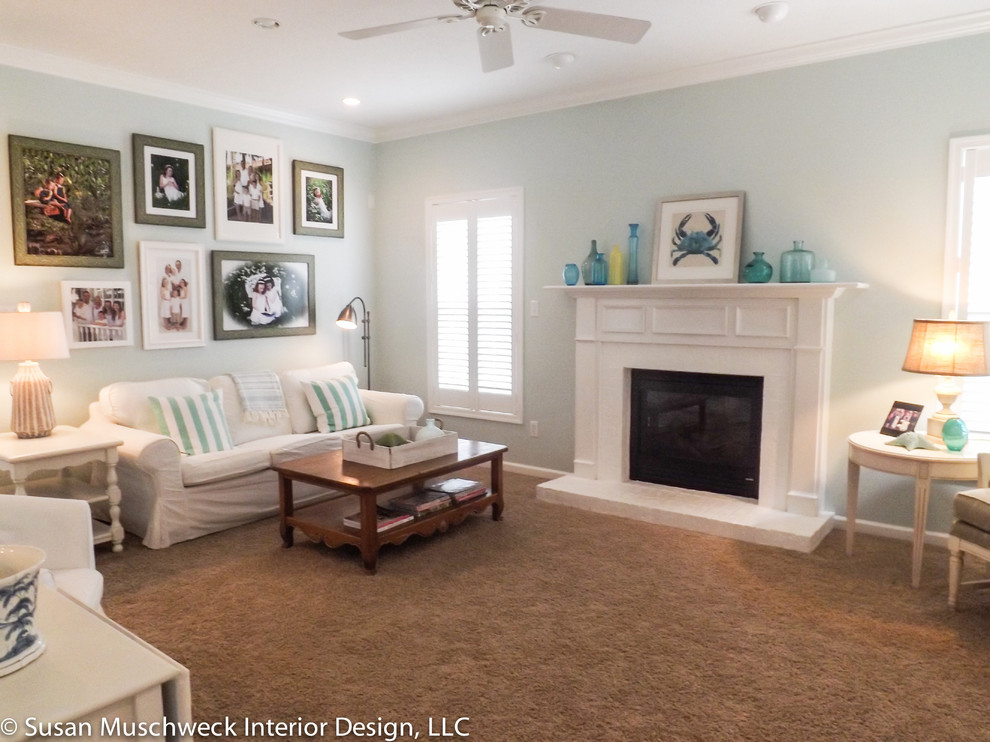 Inspiration for a mid-sized beach style open concept family room in Other with blue walls, carpet, a standard fireplace, a brick fireplace surround and a concealed tv.