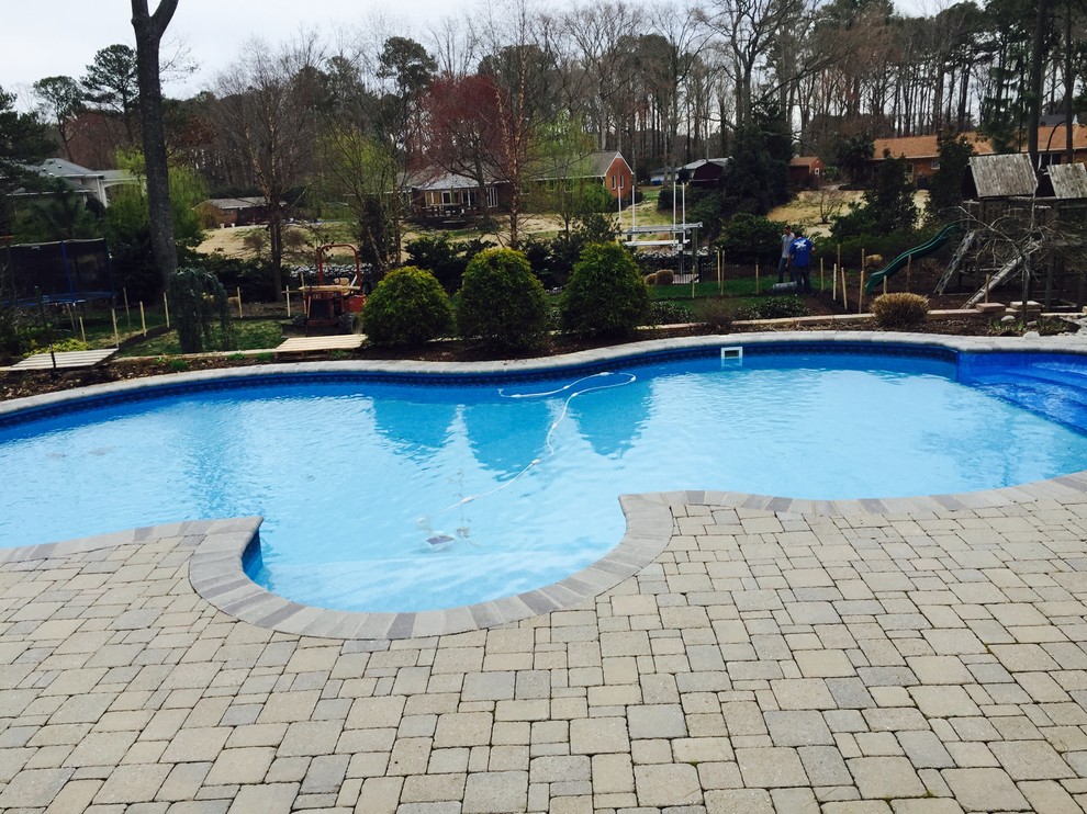 Pool fountain - mid-sized backyard stone and custom-shaped natural pool fountain idea