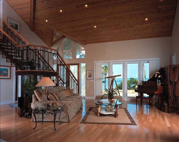 This is an example of a mid-sized beach style open concept living room in Tampa with beige walls, light hardwood floors, no fireplace and no tv.