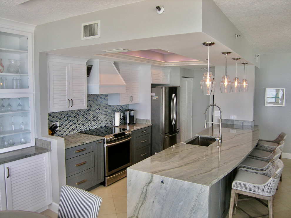 Example of a mid-sized trendy galley porcelain tile and beige floor eat-in kitchen design in Tampa with a farmhouse sink, shaker cabinets, gray cabinets, quartz countertops, metallic backsplash, glass tile backsplash, stainless steel appliances, no island and gray countertops