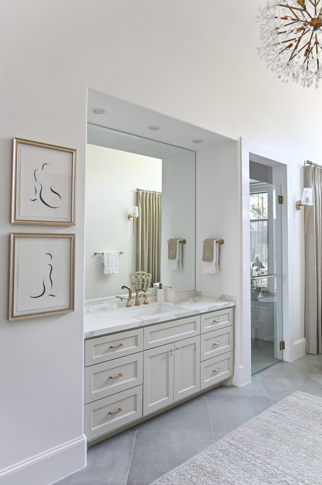 Design ideas for a large master bathroom in Houston with recessed-panel cabinets, grey cabinets, a freestanding tub, an alcove shower, porcelain floors, a drop-in sink, granite benchtops, grey floor, a hinged shower door, grey benchtops, an enclosed toilet, a single vanity, a built-in vanity and vaulted.
