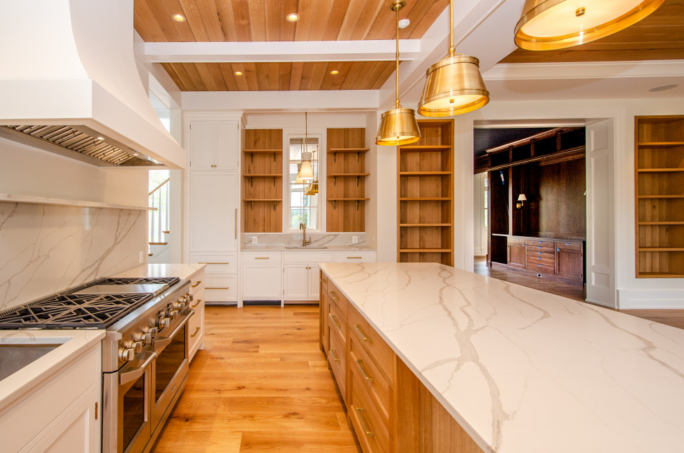 Example of a huge country light wood floor and coffered ceiling kitchen design in DC Metro with shaker cabinets, light wood cabinets, quartz countertops, white backsplash, quartz backsplash, colored appliances, an island and white countertops