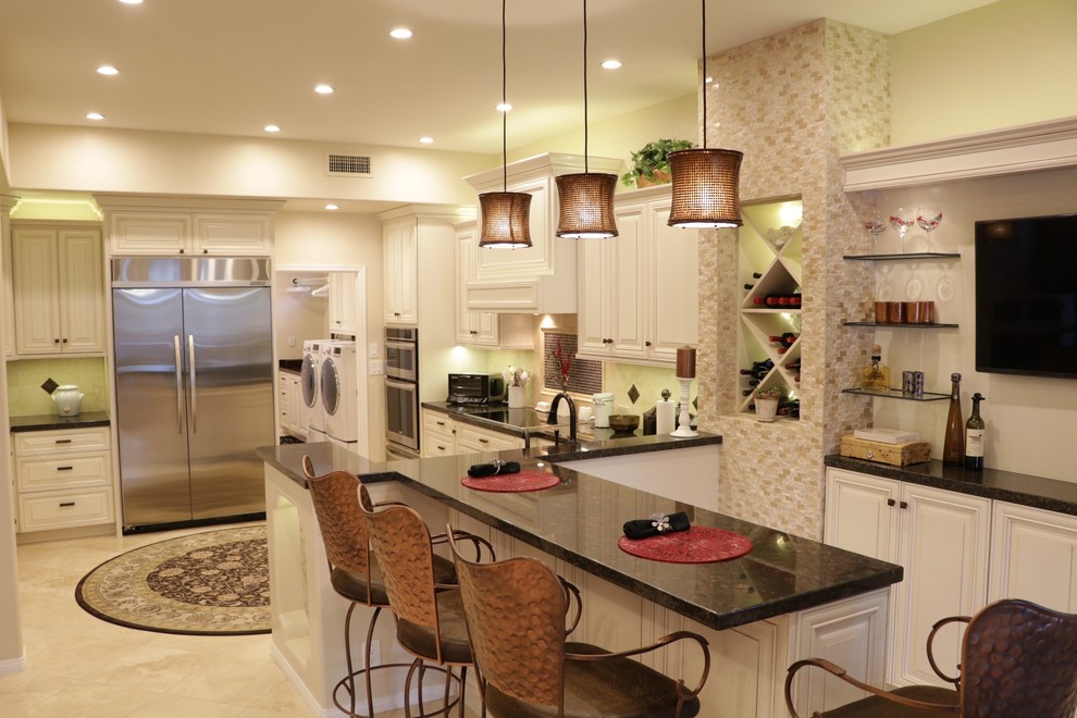 Eat-in kitchen - large transitional u-shaped porcelain tile and beige floor eat-in kitchen idea in Phoenix with raised-panel cabinets, white cabinets, quartz countertops, beige backsplash, porcelain backsplash, white appliances, a peninsula and black countertops