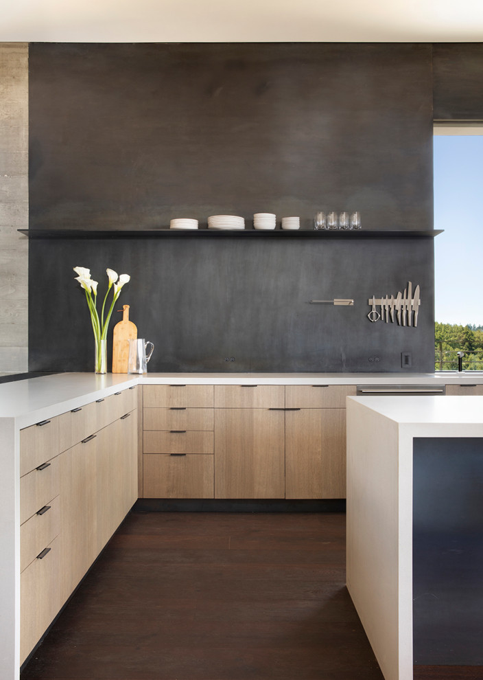 Photo of a mid-sized modern l-shaped kitchen pantry in San Francisco with a single-bowl sink, flat-panel cabinets, medium wood cabinets, quartz benchtops, metallic splashback, metal splashback, stainless steel appliances, dark hardwood floors, with island, grey floor and white benchtop.