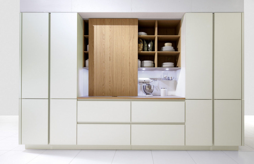 Photo of a mid-sized modern u-shaped open plan kitchen in Manchester with an integrated sink, flat-panel cabinets, white cabinets, laminate benchtops, porcelain floors and multiple islands.