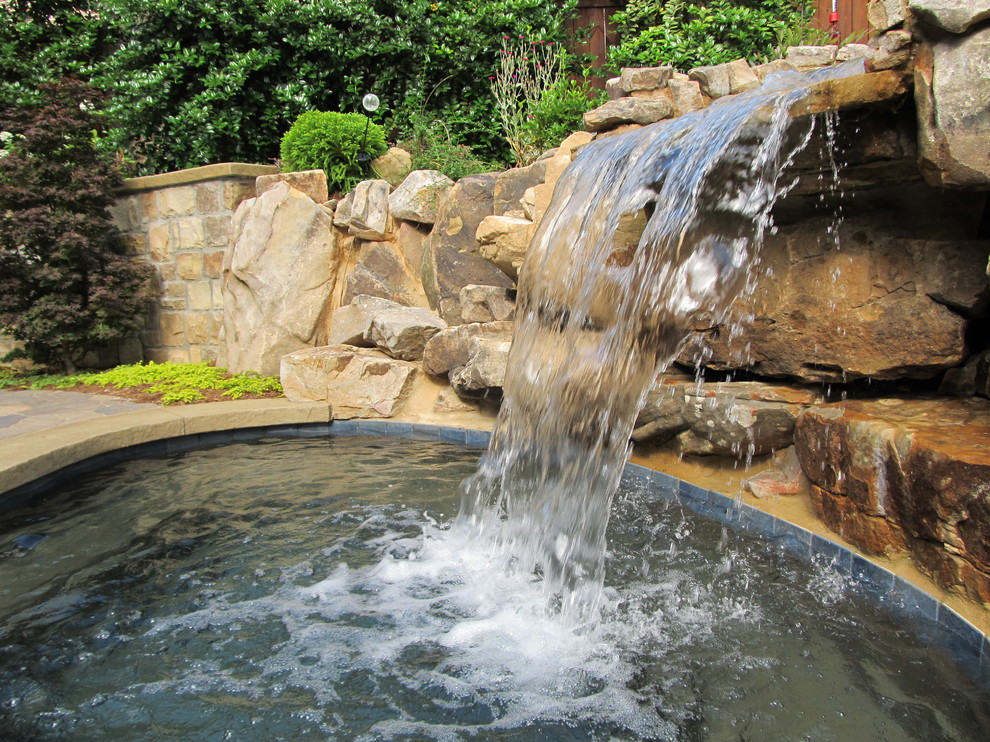 Design ideas for a mid-sized contemporary backyard full sun garden for summer in Atlanta with a water feature.