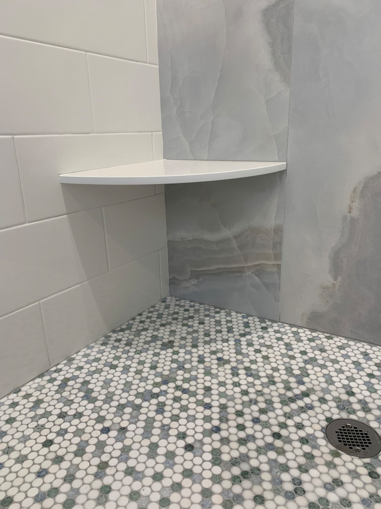Photo of a beach style bathroom in Other with furniture-like cabinets, green cabinets, an open shower, a two-piece toilet, white tile, ceramic tile, engineered quartz benchtops, grey floor, a sliding shower screen, white benchtops, a shower seat, a double vanity and a freestanding vanity.