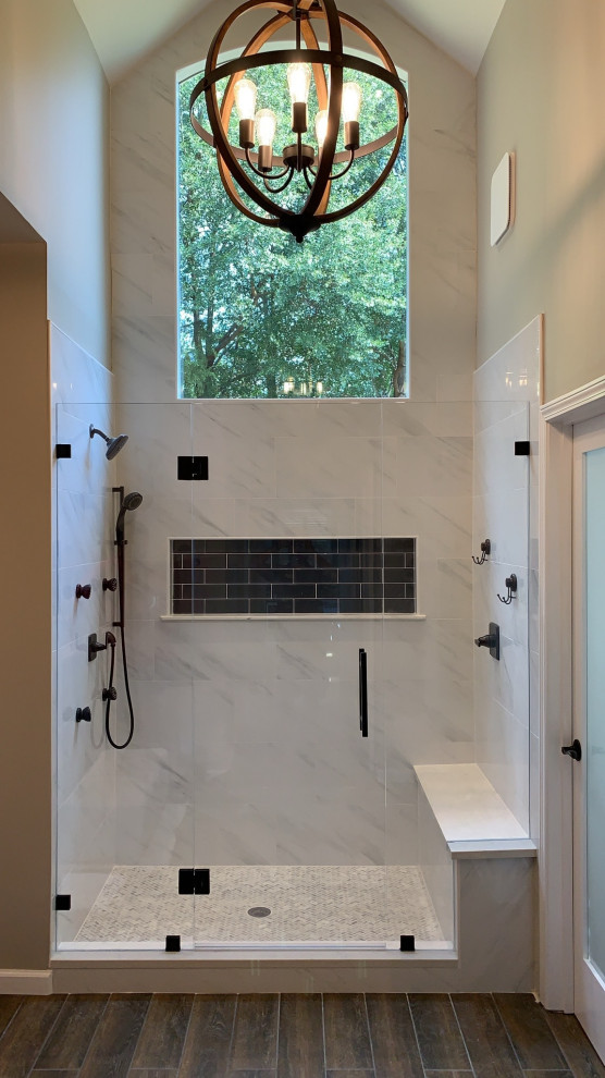 Mid-sized midcentury master bathroom in Atlanta with an alcove shower, white tile, marble, beige walls, dark hardwood floors, brown floor, a hinged shower door, a shower seat and vaulted.