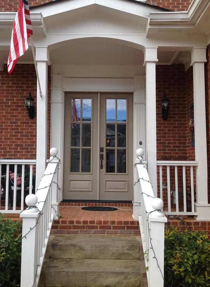 Example of a large transitional front door design in Atlanta with a brown front door