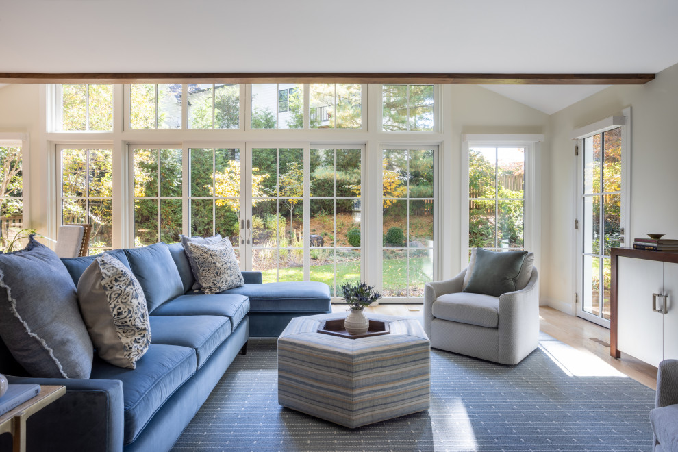 Example of a mid-sized transitional open concept light wood floor and coffered ceiling family room design in DC Metro with white walls and a concealed tv