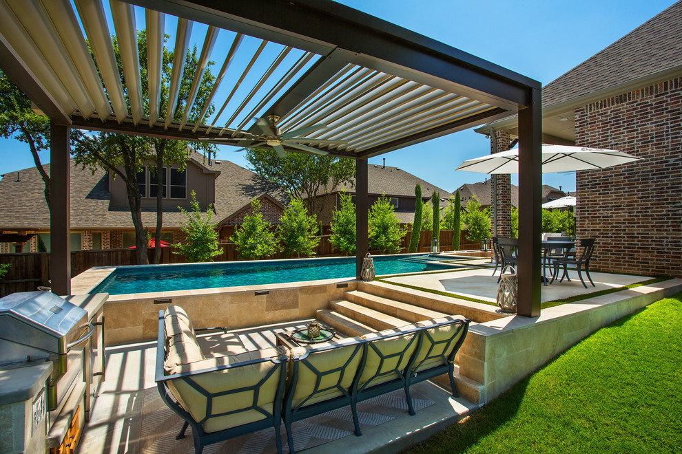This is an example of a mid-sized traditional backyard rectangular lap pool in Dallas with a hot tub and concrete slab.