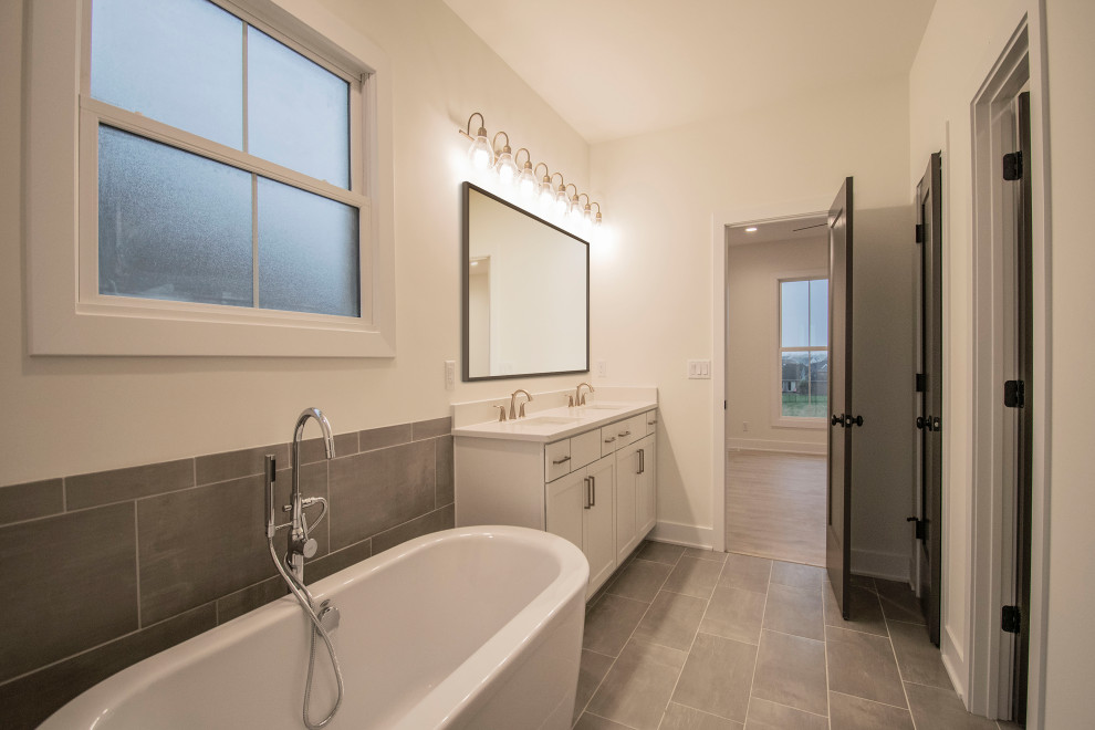 Inspiration for a large arts and crafts master bathroom in Louisville with recessed-panel cabinets, white cabinets, a freestanding tub, gray tile, ceramic tile, white walls, ceramic floors, a drop-in sink, quartzite benchtops, grey floor, white benchtops, an enclosed toilet, a double vanity and a built-in vanity.