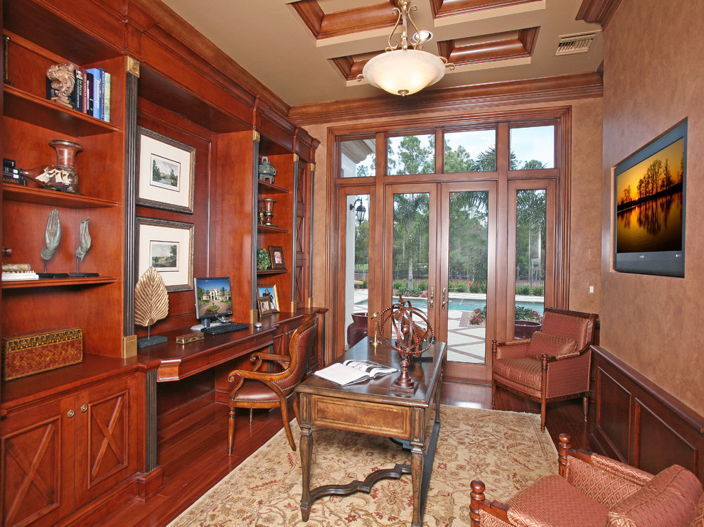 This is an example of a mediterranean home office in Miami with a built-in desk.