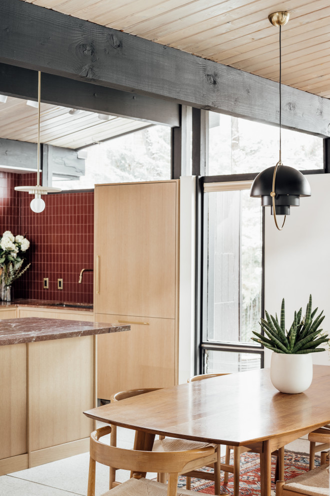 Photo of a mid-sized midcentury l-shaped eat-in kitchen in Salt Lake City with an integrated sink, flat-panel cabinets, light wood cabinets, marble benchtops, red splashback, glass tile splashback, white appliances, terrazzo floors, a peninsula, grey floor, red benchtop and exposed beam.