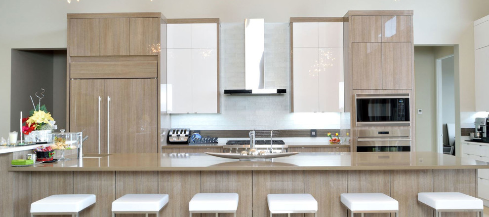 Example of a large minimalist single-wall eat-in kitchen design in Calgary with flat-panel cabinets, gray cabinets, quartz countertops, white backsplash and an island