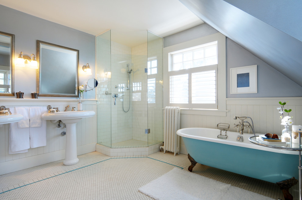 This is an example of a traditional bathroom in Calgary with a claw-foot tub and a pedestal sink.