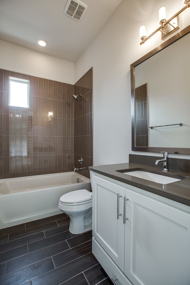 Photo of a contemporary kids bathroom in Dallas with an undermount sink, shaker cabinets, white cabinets, quartzite benchtops, a drop-in tub, a shower/bathtub combo, brown tile, glass tile, white walls and ceramic floors.