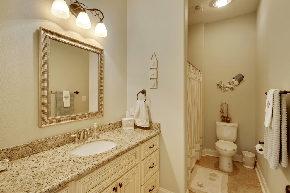 Photo of a mid-sized contemporary bathroom in Other with an undermount sink, raised-panel cabinets, white cabinets, granite benchtops and medium hardwood floors.
