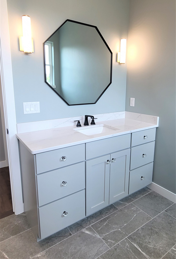 Inspiration for a mid-sized transitional kids' gray tile and ceramic tile ceramic tile, gray floor and single-sink drop-in bathtub remodel in Cedar Rapids with shaker cabinets, gray cabinets, blue walls, an undermount sink, quartz countertops, white countertops and a built-in vanity