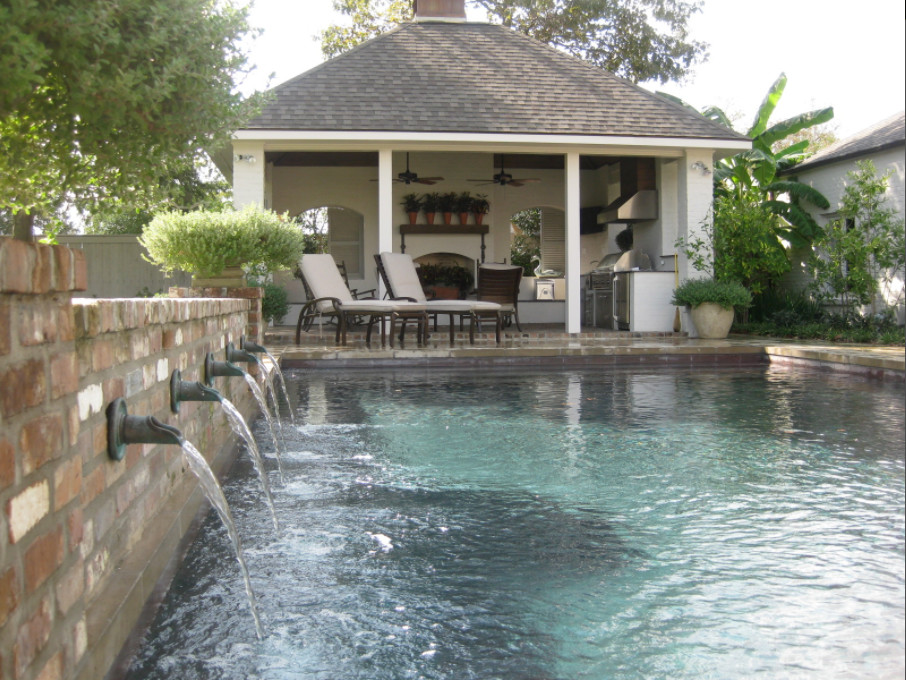 Design ideas for a large transitional backyard custom-shaped lap pool in New Orleans with a hot tub.