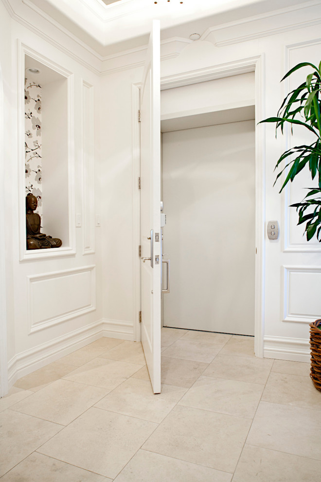 This is an example of a mid-sized beach style foyer in Las Vegas with white walls, travertine floors, a single front door, a white front door, beige floor, wallpaper and decorative wall panelling.