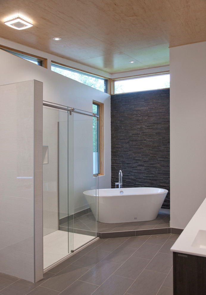 Inspiration for a large modern master bathroom in DC Metro with an alcove shower, a one-piece toilet, stone tile, white walls, ceramic floors, grey floor, a sliding shower screen, flat-panel cabinets, dark wood cabinets, a drop-in tub, black and white tile, an undermount sink, wood benchtops and white benchtops.