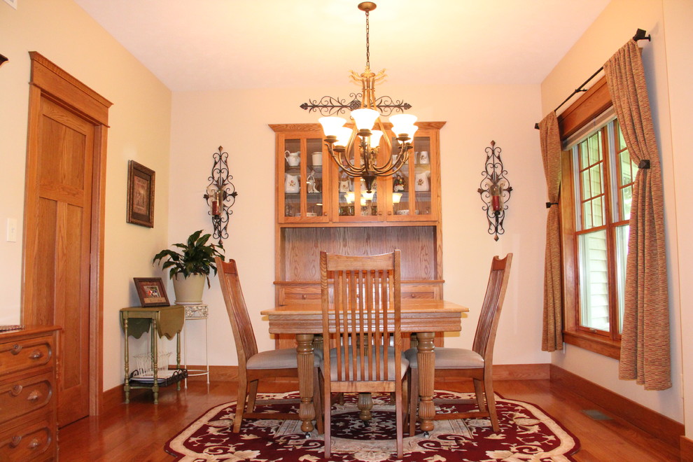 This is an example of an arts and crafts dining room in Chicago with medium hardwood floors.
